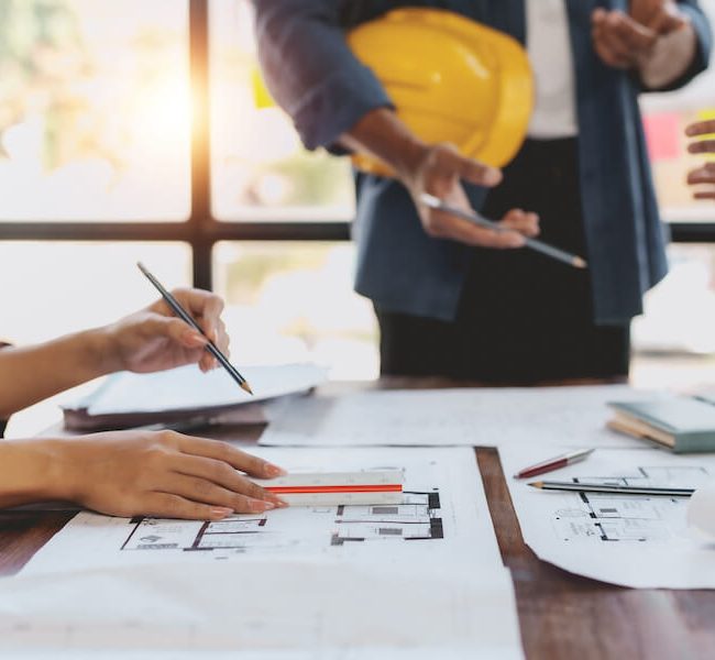 Stock image of people working on architectural plans