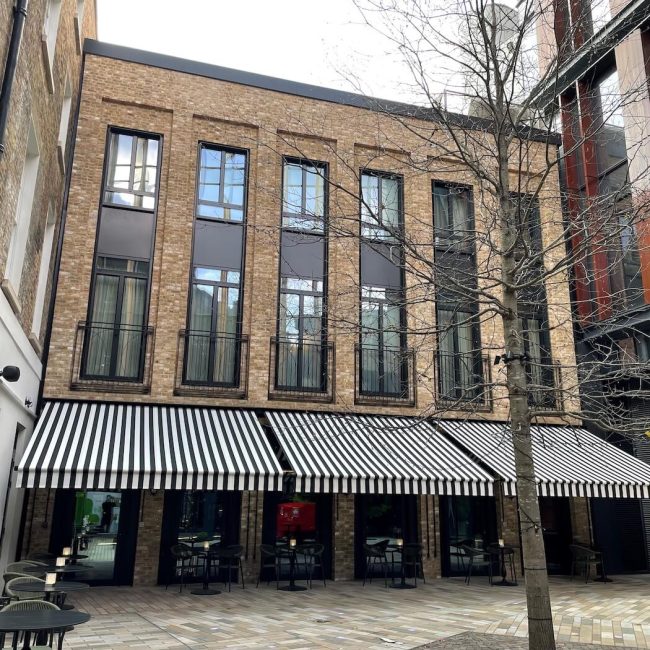 Building exterior of Sun Street Hotel and courtyard